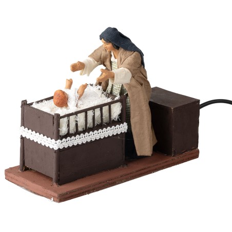 Mother taking baby from cradle series 12 cm in motion for