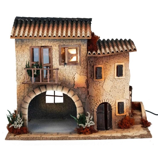 Borgo illuminato con donna in movimento per presepe Mondo