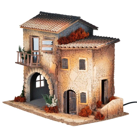 Illuminated village with moving woman for Mondo nativity scene