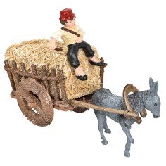 Man on donkey carrying a cart loaded with hay for