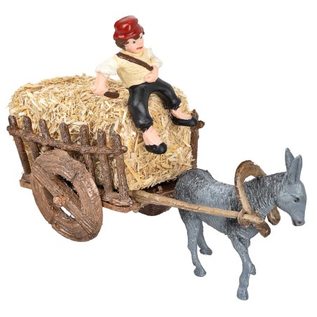 Man on donkey carrying a cart loaded with hay for