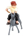 Man with whip riding a donkey