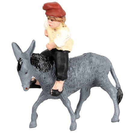 Man on a donkey transporting a cart loaded with hay for