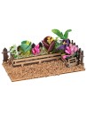Fenced small garden with assorted flowers and plants cm