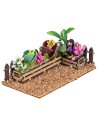 Fenced small garden with assorted flowers and plants cm