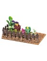 Fenced small garden with assorted flowers and plants cm