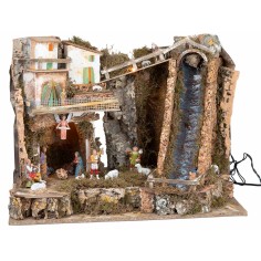 Illuminated nativity scene with steep waterfall and Landi