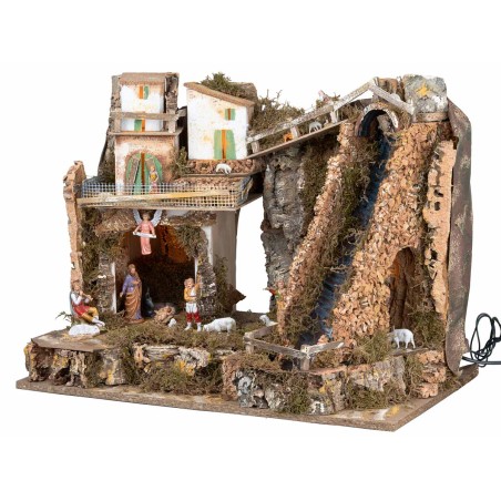 Illuminated nativity scene with steep waterfall and Landi