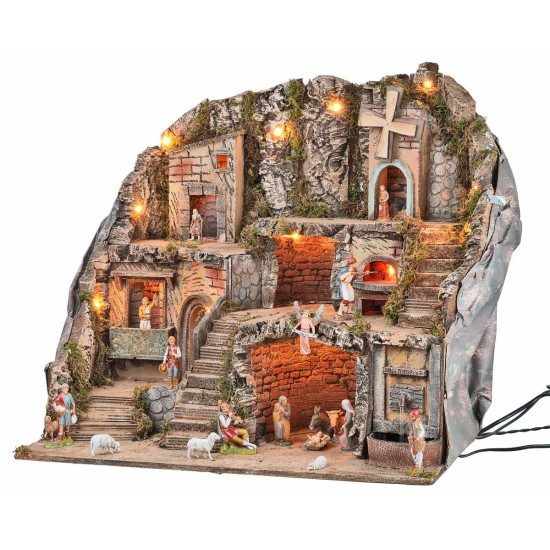 Presepe illuminato con statue, fontana, fuoco e mulino a vento