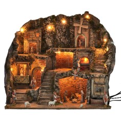 Illuminated nativity scene with statues, fountain, fire, and windmill 2