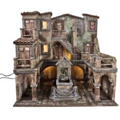 Village with illuminated square and fountain with a pump