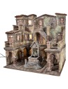 Village with illuminated square and fountain with a pump