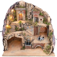 Illuminated nativity scene with fountain and moving donkey at