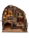 Illuminated nativity scene with fountain and moving donkey at