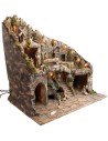 Presepe illuminato con statue, ruscello, forno e mulino a vento