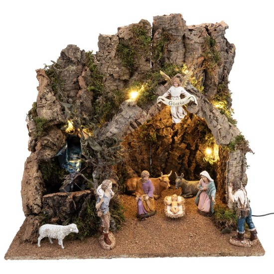 Illuminated nativity scene with cork bark hut and