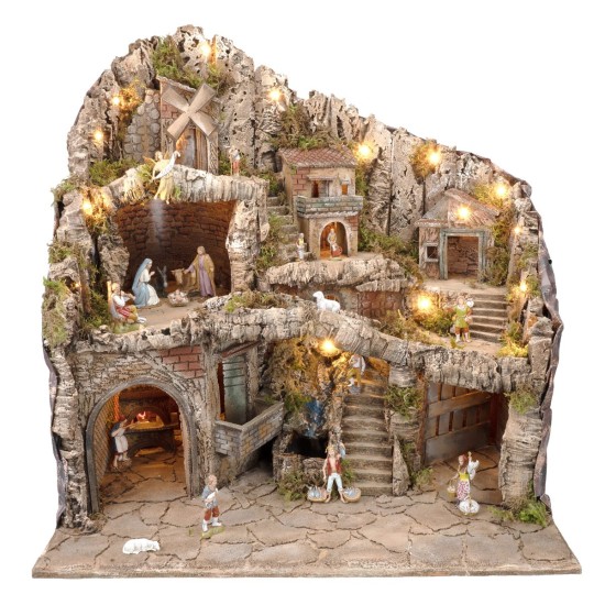 Illuminated nativity scene with statues, stream, oven and