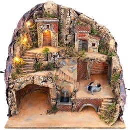 Illuminated nativity scene with fountain and