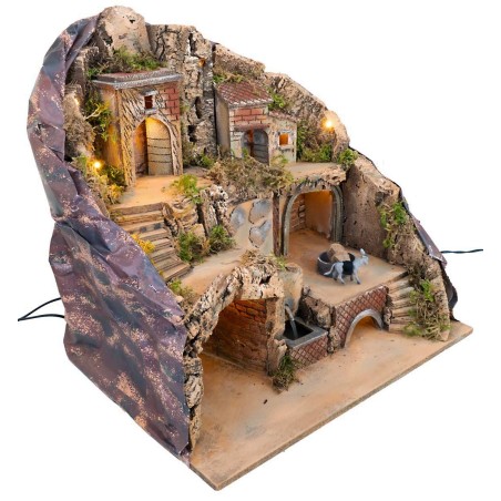 Illuminated nativity scene with fountain and