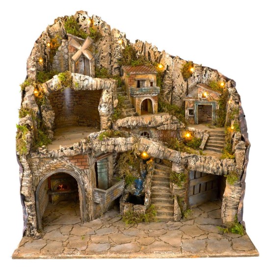 Illuminated nativity scene with statues, stream