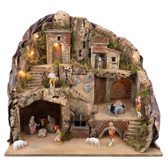 Illuminated nativity scene with fountain and