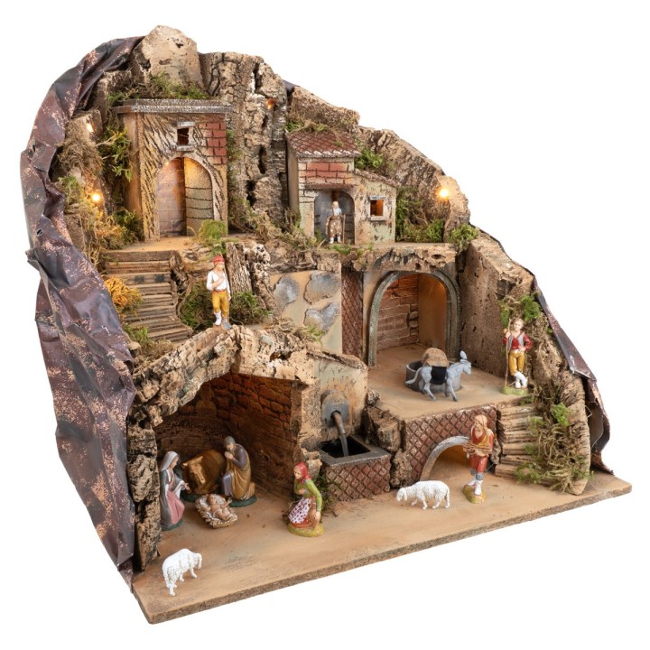 Pesebre iluminado con fuente y burro en el molino