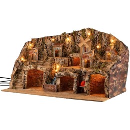 Pesebre iluminado con cuevas, casitas, arroyo