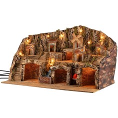 Pesebre iluminado con cuevas, casitas, arroyo