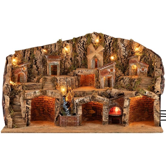 Pesebre iluminado con cuevas, casitas, arroyo