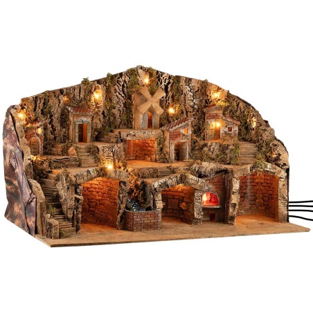 Pesebre iluminado con cuevas, casitas, arroyo