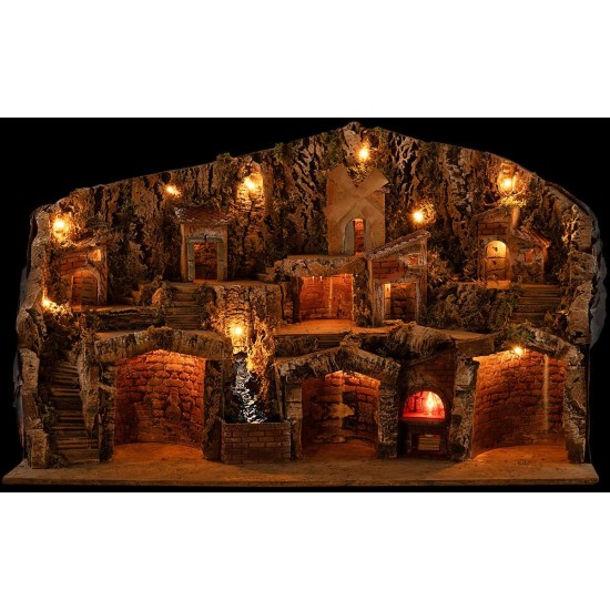 Pesebre iluminado con cuevas, casitas, arroyo