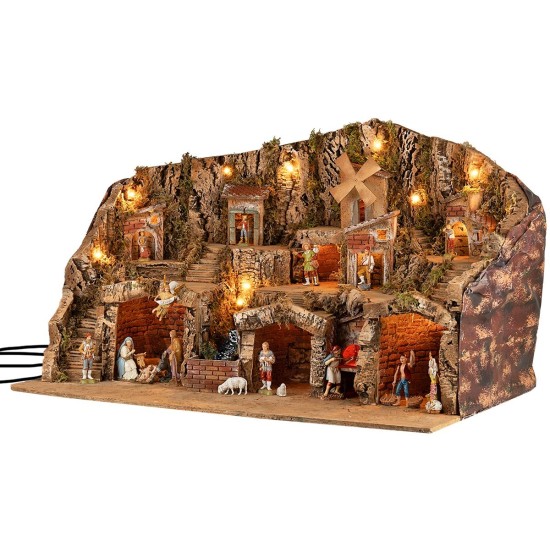 Illuminated nativity scene with caves, small houses, stream